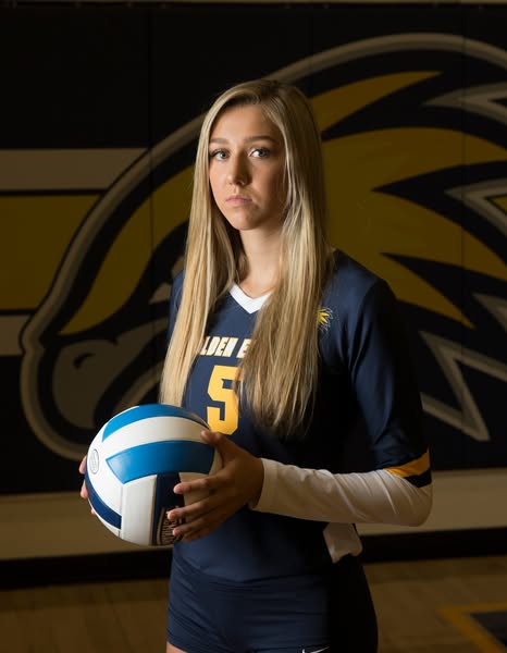 Avery Nelson in her LCCC Volleyball uniform holding a volleyball