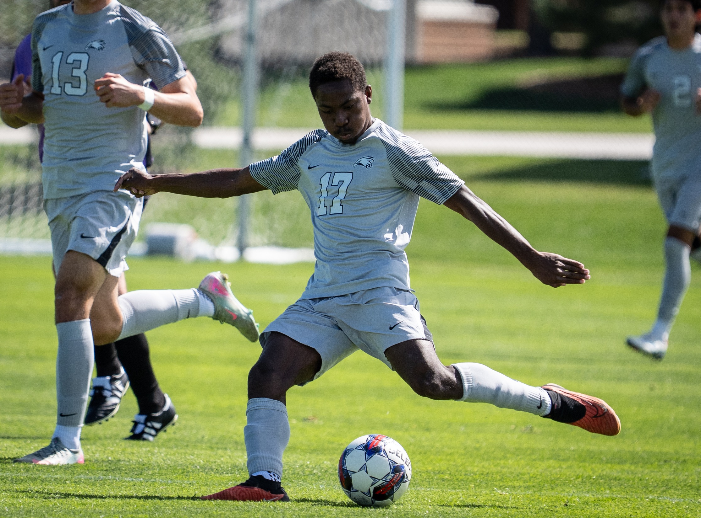 LCCC Men's Soccer Player striking a soccer ball. 