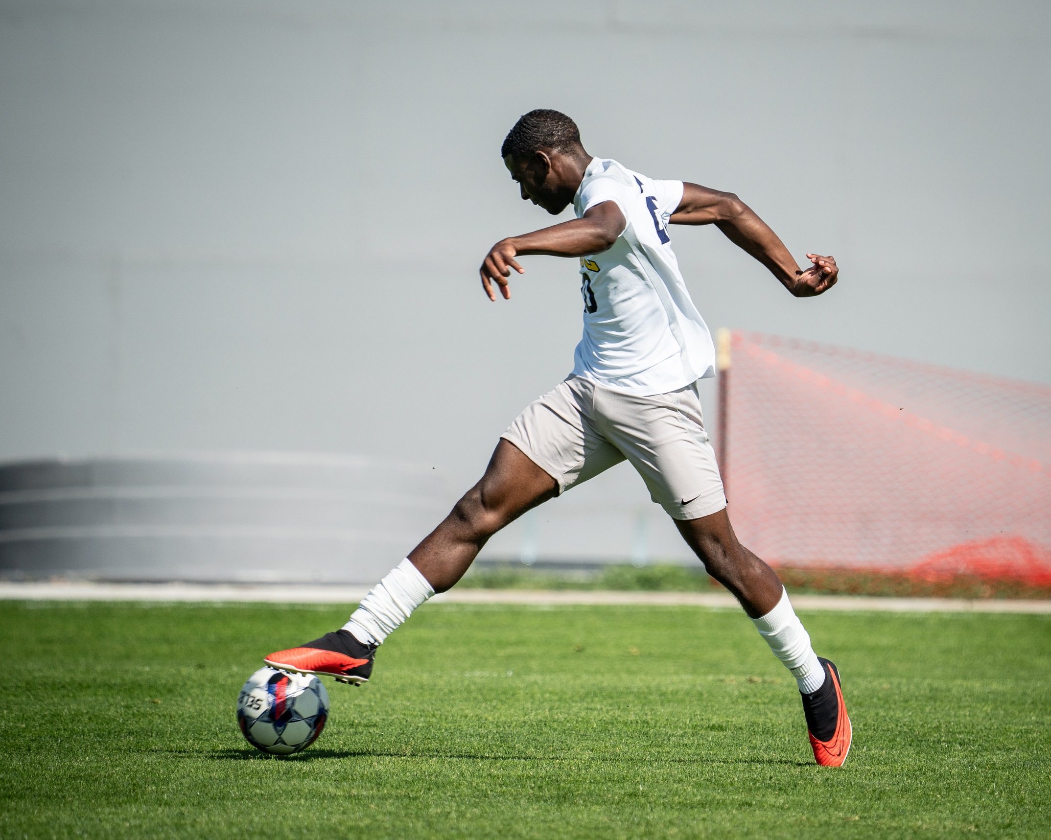 LCCC Men's Soccer Player dribbling the ball in open space. 