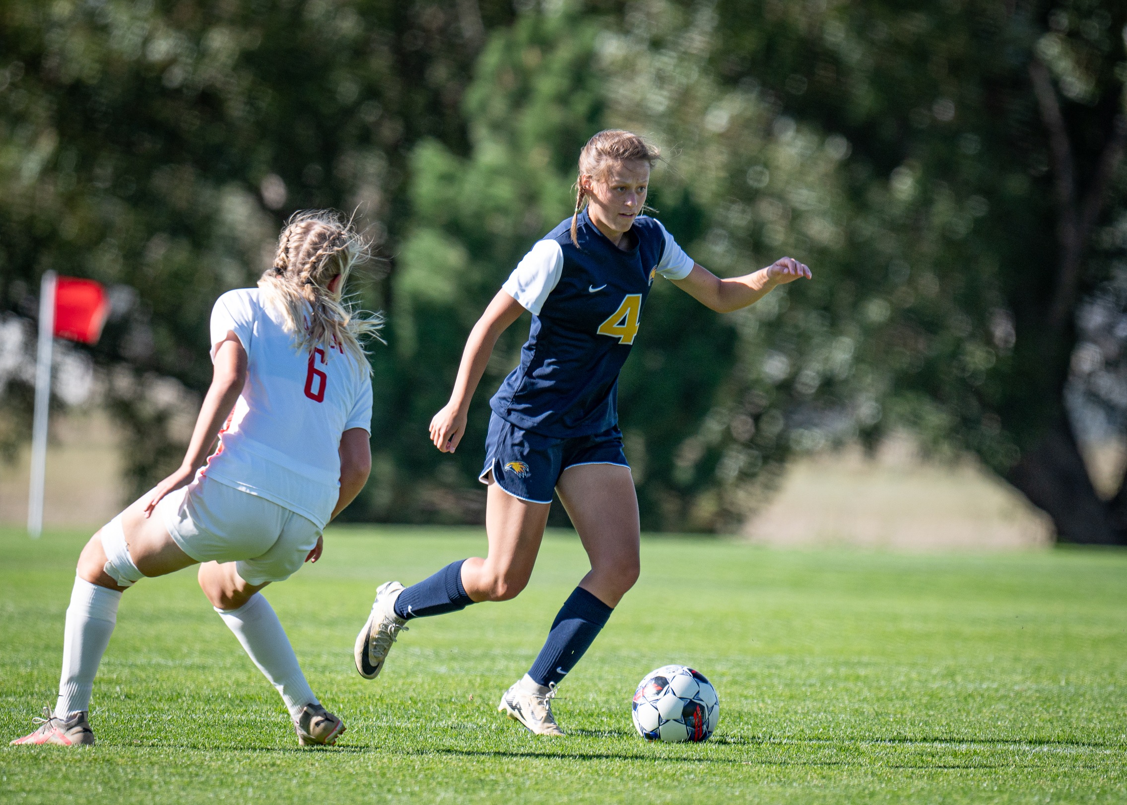 Haley Pierson dribbling a soccer ball past a defender