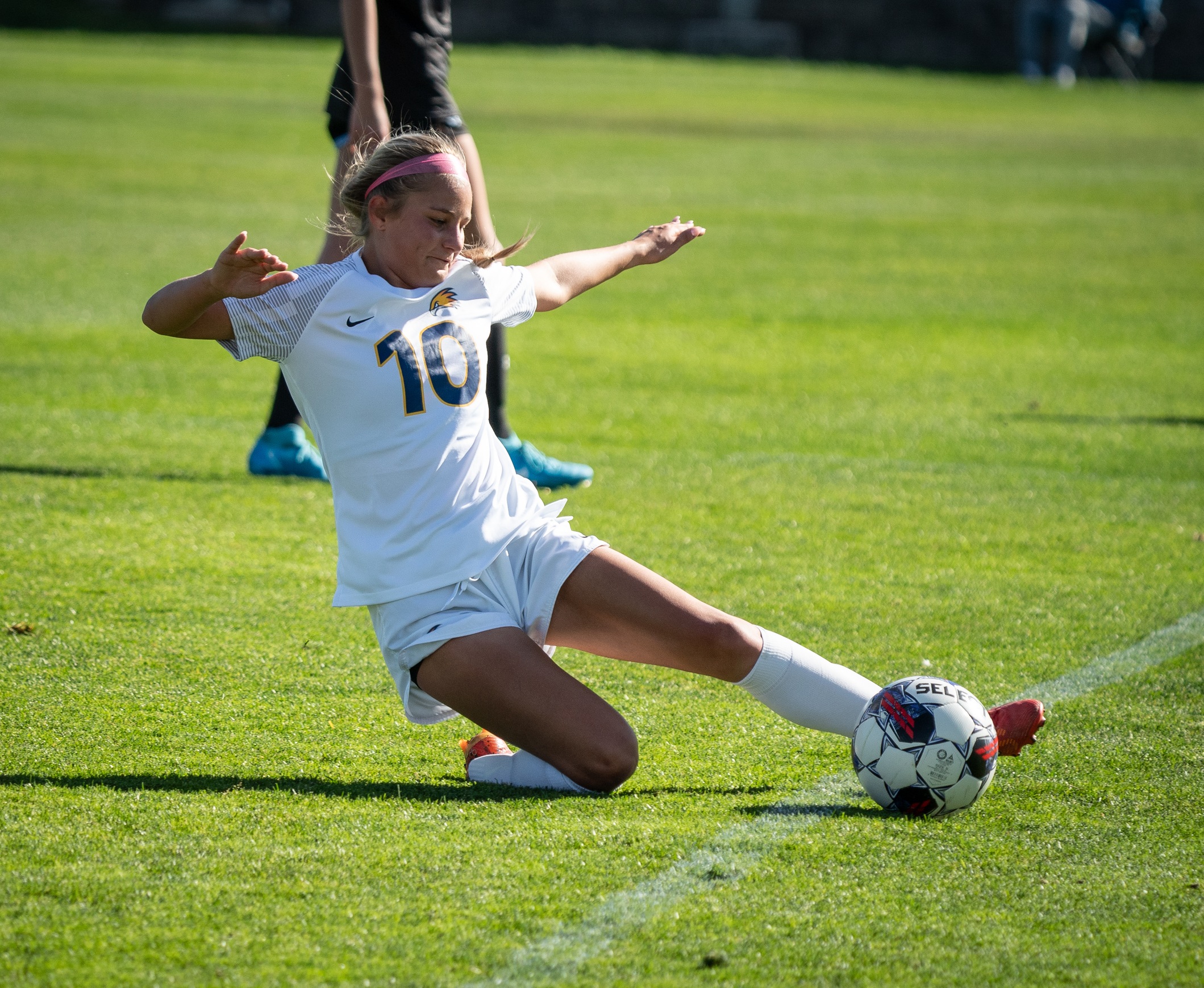 Madi Moore sliding to keep the ball in play