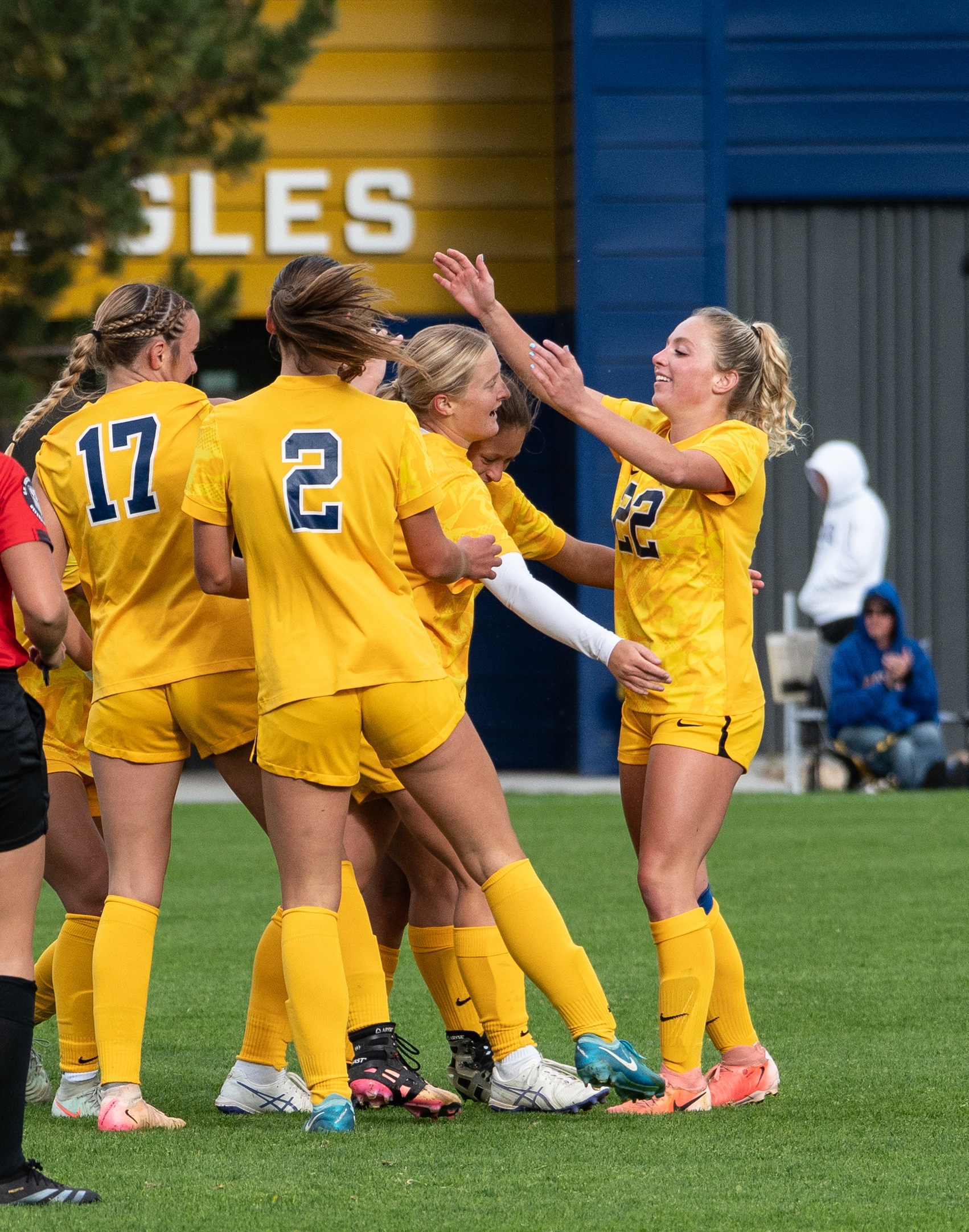 Teammates celebrating with Emily Sheather after scoring a goal